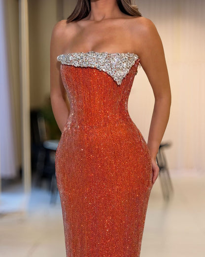 Close-up of silver crystal neckline on copper orange corset evening gown