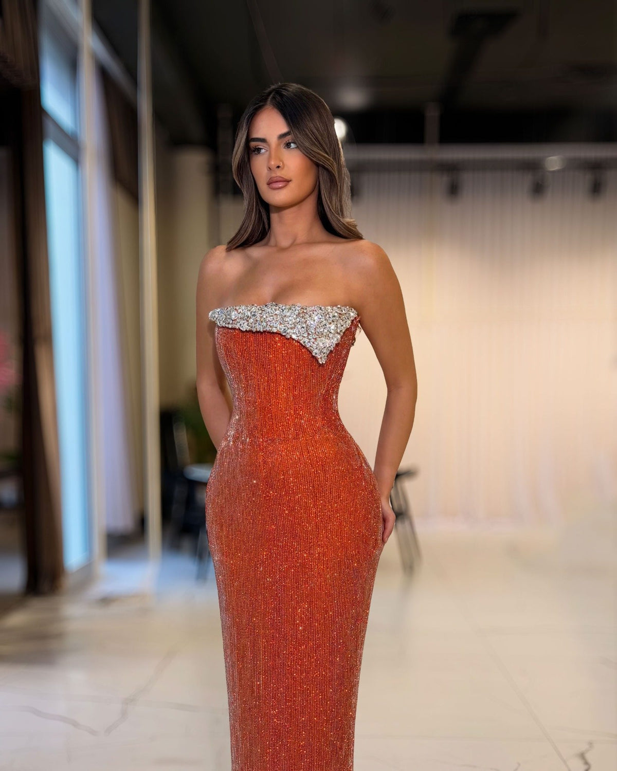 Copper orange crystal strapless corset gown, angled full-length view