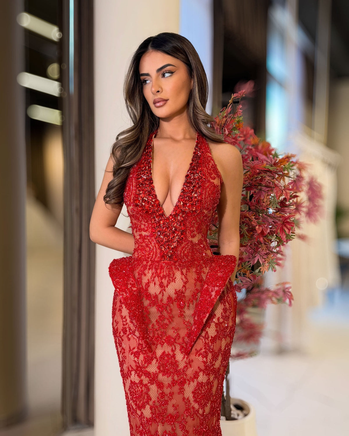Red crystal embellished lace halter gown with deep V neckline, front view