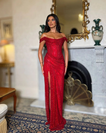 Red glitter off-shoulder corset evening gown with draped neckline, fitted silhouette and high slit, full-length front view