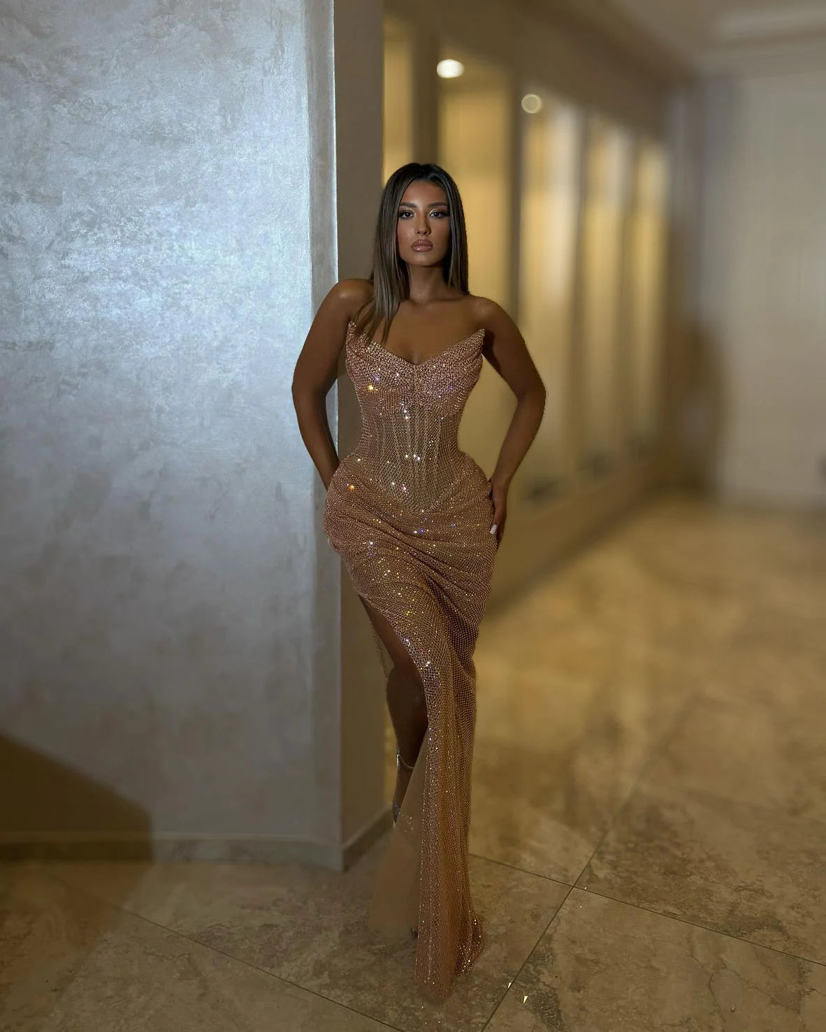 Full-length rose gold crystal strapless corset evening gown with sculpted sweetheart neckline, gathered hips and thigh-high slit