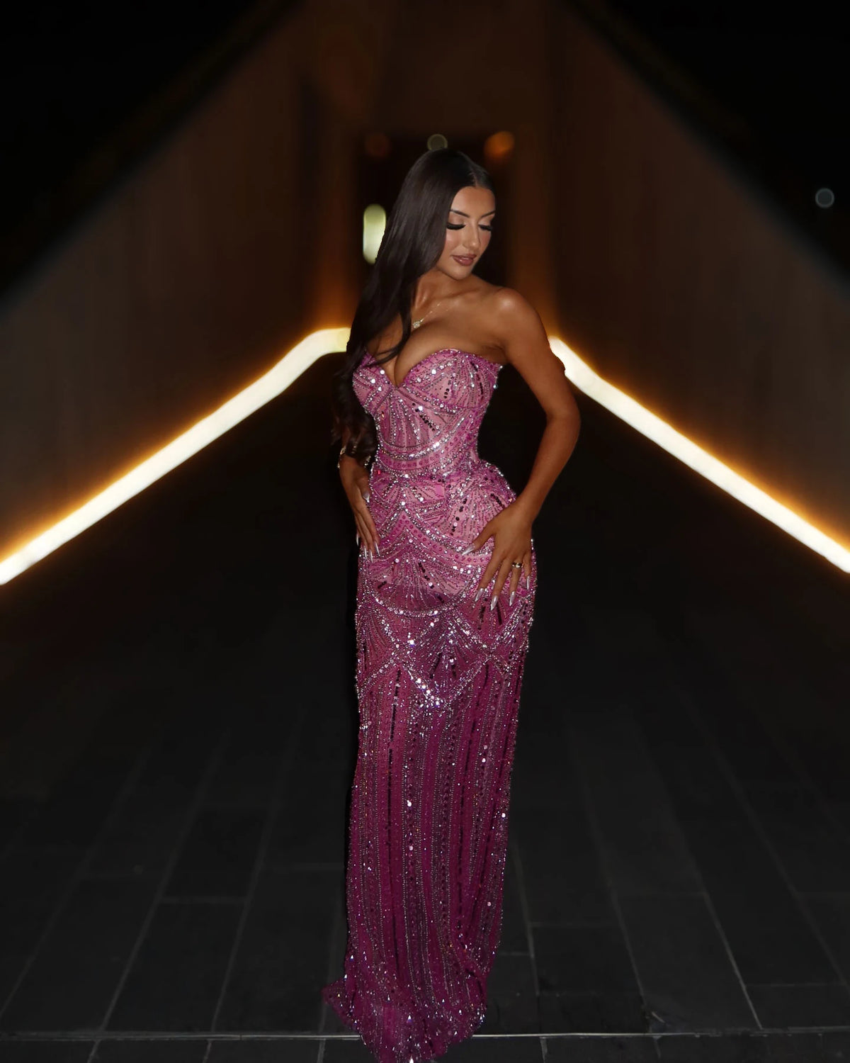 Rose pink crystal beaded strapless mermaid gown with sculpted waist, three-quarter evening look