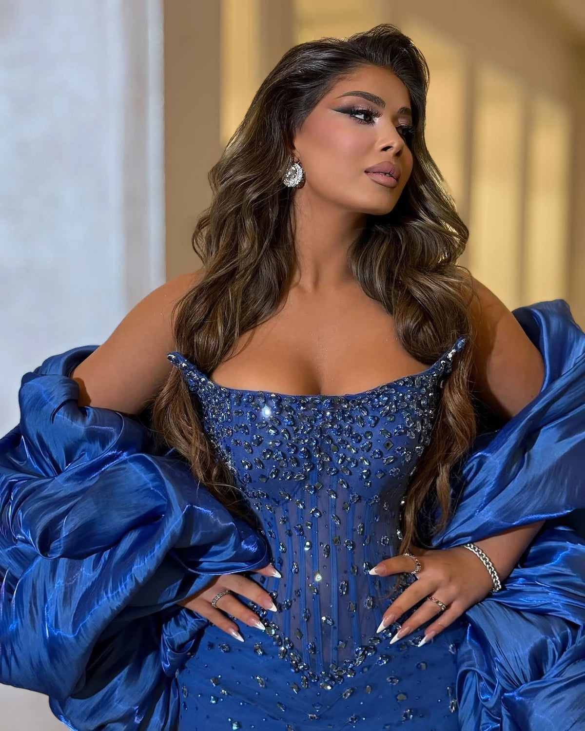Royal blue crystal strapless corset gown with raised pointed neckline, fitted sheer bodice and blue beadwork